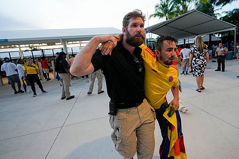 A security agent assists a fan